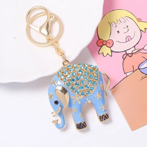 Detailed shot of a luxury elephant keychain with light blue enamel and sparkling crystals
