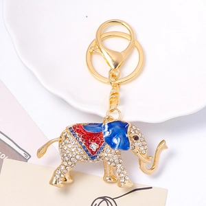 Sparkling elephant keychain with crystal rhinestones and blue enamel on gold-plated alloy