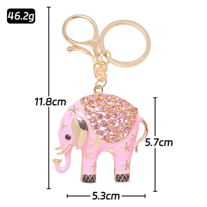 Pink enamel elephant keychain with gold stars, rhinestones and clasp on white background