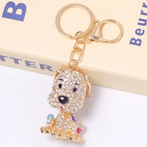 Dettaglio ravvicinato del portachiavi a forma di cane con strass e finiture in smalto