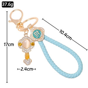 Lucky Ru Yi keychain with faux cat-eye stone, blue leather cord, and golden rhinestones
