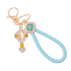 Detail of Ruyi jade keychain with light blue leather rope and sparkling crystals