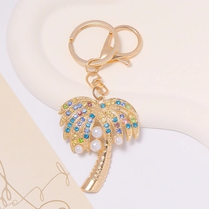 Detailed palm tree keychain featuring colorful rhinestones and white pearls on gold metal