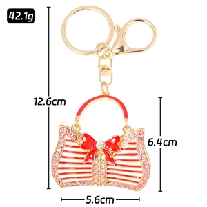 Sparkling gold keychain with red striped handbag charm and pink rhinestones