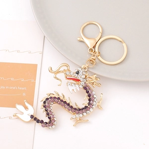 Exquisite Chinese dragon keychain with purple rhinestones and white enamel in gold finish