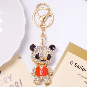 Detailed view of panda keychain with sparkling rhinestones and red enamel vest