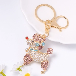 Détail d'un porte-clés caniche avec strass colorés sur alliage doré et fermoir mousqueton