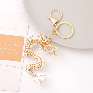 Detailed macro view of golden Chinese dragon keychain with hollowed-out metal scales texture