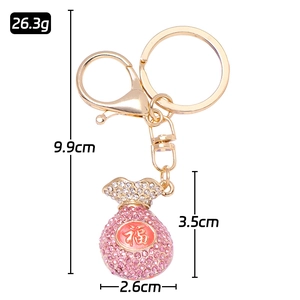 Porte-clés sac de fortune doré avec strass roses et caractère chinois de chance