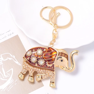Detailansicht eines goldenen Elefanten-Schlüsselanhängers mit Strass und floraler Emaille