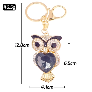 Porte-clés chouette doré avec cristal de cœur violet et strass blancs brillants
