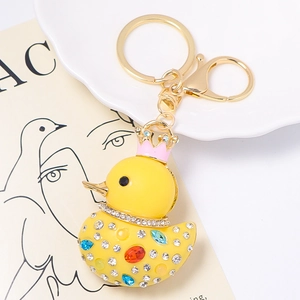 Detail of yellow resin crown duck keychain with colorful rhinestones and golden lobster clasp