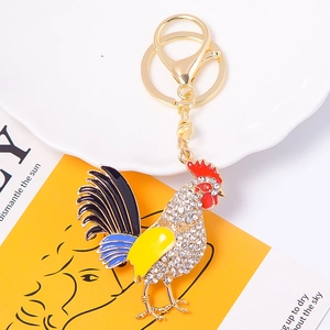 Golden rooster crystal keychain with white rhinestones and red enamel cockcomb detail
