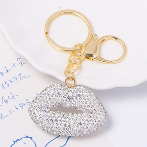 Close-up of golden lip-shaped keychain featuring sparkling rhinestones and lobster clasp