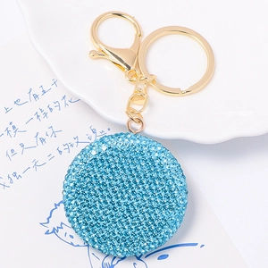 Portachiavi con faccina sorridente in strass azzurro brillante e chiusura dorata