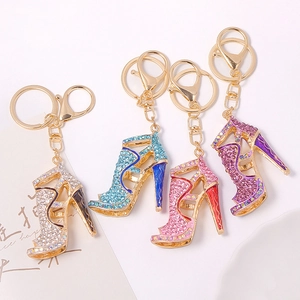 Close-up of four rhinestone high heel keychains in silver, blue, pink, and purple colors