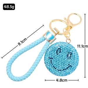 Portachiavi smiley con strass blu con cinturino in pelle intrecciata e gancio dorato
