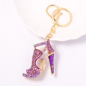Detail of high heel keychain with purple rhinestones and gold alloy metal hardware