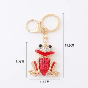 Sparkling frog keychain with red and white rhinestones and dimensions shown on white background