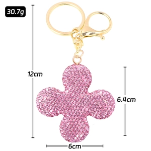 Detail showing dimensions of sparkling pink rhinestone four-leaf clover keychain with measurements