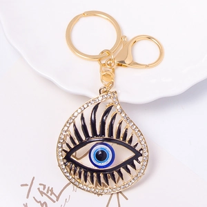 Macro shot of evil eye keychain with gold teardrop frame and sparkling rhinestones