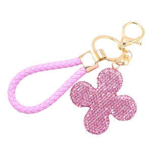 Detail of pink woven leather cord and sparkling rhinestone clover charm keychain