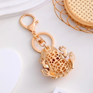Golden frog keychain with rhinestones and coins detail for luck and fortune
