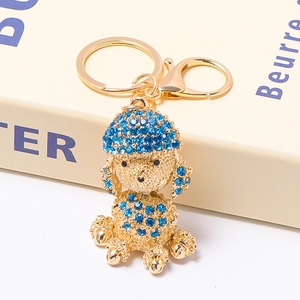Detail of blue rhinestone-studded poodle keychain with golden plating and lobster clasp