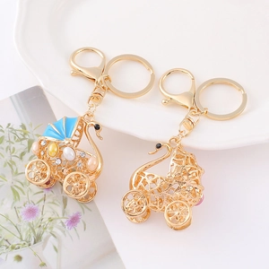 Elegant gold alloy swan carriage keychain with blue enamel and colorful rhinestones