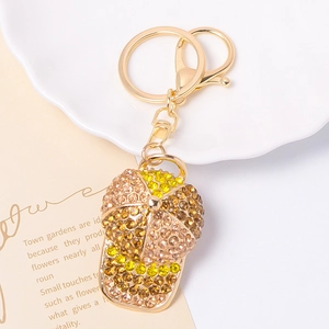 Detailed close-up of rhinestone baseball cap keychain with gold clasp and lobster hook