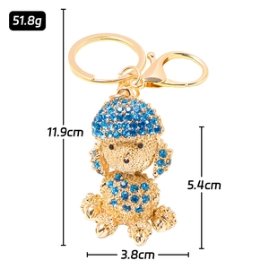 Golden poodle keychain with blue rhinestones featuring a lobster clasp and ring