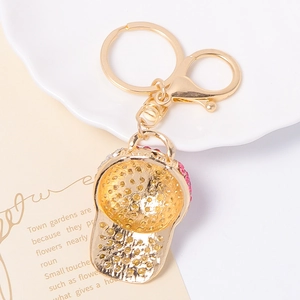 Sparkling rhinestone baseball cap keychain with pink crystals and gold metal clasp