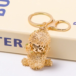 Golden bear keychain with textured surface and heart-shaped face detail for bags
