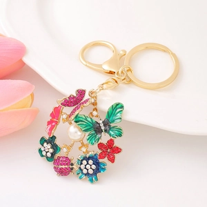 Porte-clés fleuri avec papillon émaillé et coccinelle en cristal sur assiette
