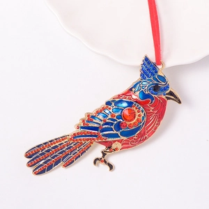 Close-up of red bird ornament with enamel craft, sparkling rhinestones and red velvet cord