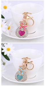 Detail of pink and blue heart-shaped fortune bag keychains with sparkling rhinestones