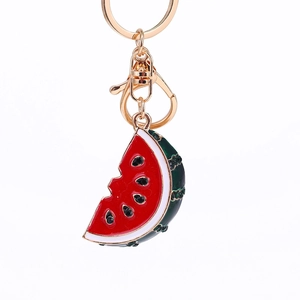 Creative watermelon slice metal keychain with red enamel and rhinestones on white background