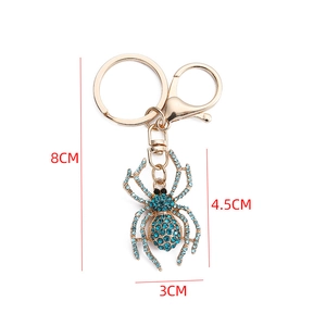 Detailed blue rhinestone spider keychain with gold metal plating and dimensions
