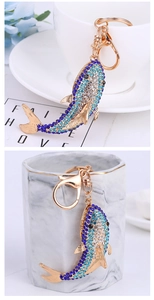 Detail of dolphin keychain with blue crystals and rose gold metal lobster clasp