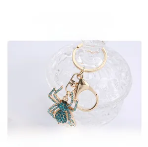 Detailed macro view of the crystal spider keychain with blue rhinestones and gold clasp