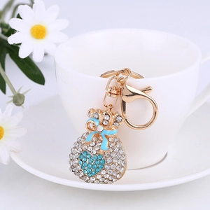 Sparkling crystal money bag keychain with blue heart detail and golden lobster clasp