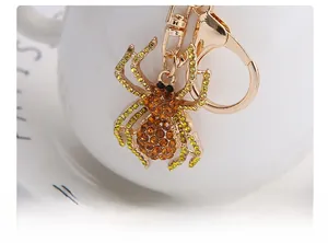 Macro shot of gold spider keychain featuring amber rhinestones and lobster clasp