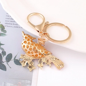 Detailed view of a gold hollow bird keychain with rhinestone accents on a metal ring