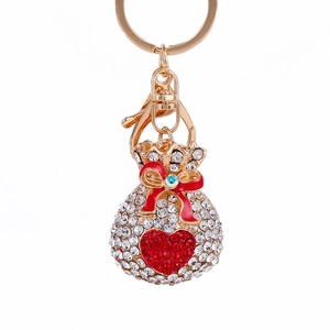 Sparkling crystal heart lucky bag keychain with gold alloy finish and red rhinestones