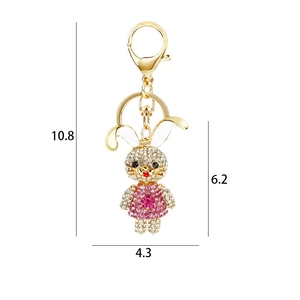 Golden rabbit keychain with pink and white rhinestones and dimensions 10.8x6.2x4.3cm
