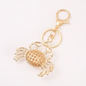 Golden crab keychain with hollow grid design and lobster clasp for marine animal accessories