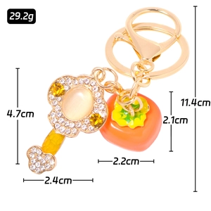 Golden key and orange persimmon crystal keychain with sparkling cat eye stone charms