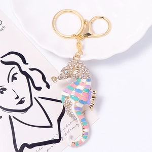 Detailed macro view of seahorse keychain with colorful enamel and sparkling rhinestones