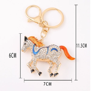 Golden horse keychain with white rhinestones and orange enamel accents, 11.5cm length