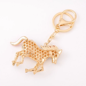Golden striped horse keychain with intricate floral hollow design and metal ring